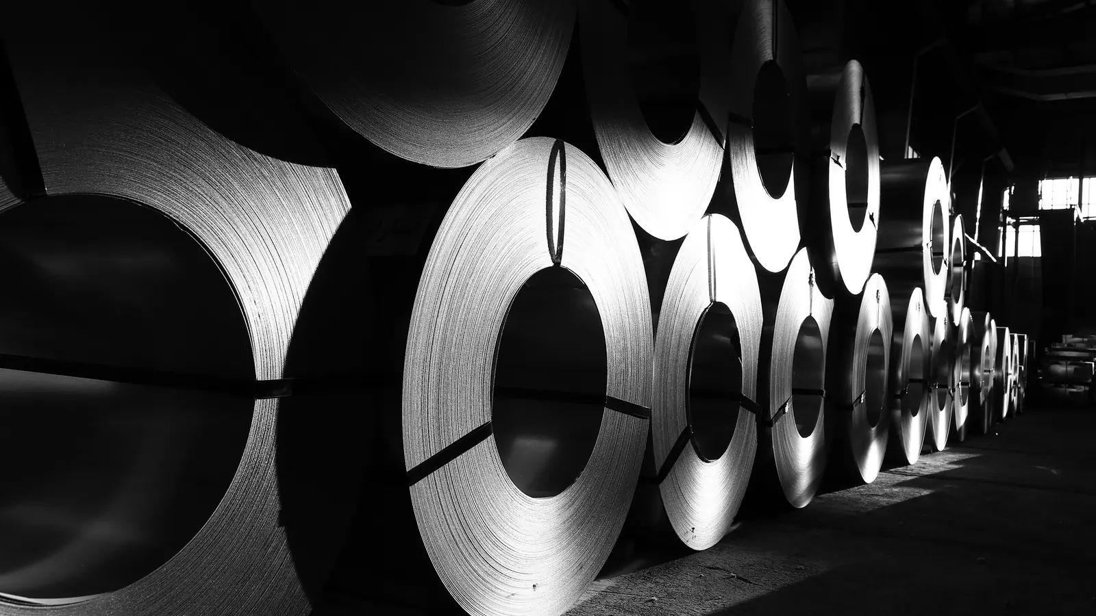 Coils and sheets of steel in a warehouse